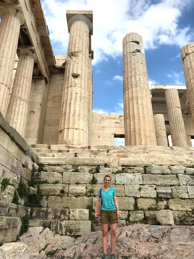 A college student stands in front of the Pantheon in Greece